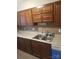 Traditional kitchen with wood cabinetry, granite countertops, stainless steel sink, and faucet at 9156 Black Heath Cir, Charlotte, NC 28214