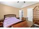 Spacious bedroom with dark wood furniture and natural light from a large window at 1008 Autumn Ln, Concord, NC 28025