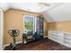 Bedroom featuring hardwood floors, neutral walls, a ceiling fan, and a window with natural light at 1008 Autumn Ln, Concord, NC 28025