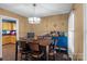 Cozy dining room featuring a wooden table, a bright blue accent cabinet, and modern lighting at 1008 Autumn Ln, Concord, NC 28025