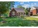 Charming brick home featuring a lush green lawn and well-maintained landscaping in a desirable neighborhood at 1008 Autumn Ln, Concord, NC 28025