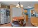 Bright eat in kitchen with stainless steel appliances, tile backsplash, and wood-look flooring at 1008 Autumn Ln, Concord, NC 28025