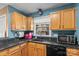Updated kitchen featuring dark granite countertops, wood cabinets, and stainless steel appliances at 1008 Autumn Ln, Concord, NC 28025
