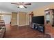 Open living room with hardwood floors, a large TV, and a view of other rooms at 1008 Autumn Ln, Concord, NC 28025
