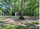 Large backyard with outbuildings and mature trees at 1031 Lester Trl, Iron Station, NC 28080