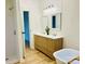Bright bathroom featuring a wood vanity with double sinks, a modern soaking tub, and a walk-in shower at 1031 Lester Trl, Iron Station, NC 28080