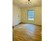 Bedroom with wood-look floors and a window with a wooded view at 1031 Lester Trl, Iron Station, NC 28080