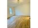 Spacious bedroom featuring wood-look floors and a large window providing natural light at 1031 Lester Trl, Iron Station, NC 28080