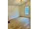 Bedroom with wood-look floors and a window with a wooded view at 1031 Lester Trl, Iron Station, NC 28080