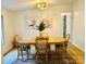 Well-lit dining room with wood table and chairs on a colorful rug at 1031 Lester Trl, Iron Station, NC 28080