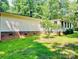 Cozy home featuring vinyl siding, a brick foundation, and a well-maintained lawn at 1031 Lester Trl, Iron Station, NC 28080