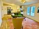 Bright living room featuring modern decor, a cozy green sofa, and ample natural light at 1031 Lester Trl, Iron Station, NC 28080