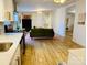 Open-concept living area featuring wood-look floors, modern decor, and a stylish fireplace at 1031 Lester Trl, Iron Station, NC 28080
