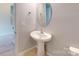 Charming half-bath with pedestal sink and modern fixtures at 10848 Tailwater St, Davidson, NC 28036
