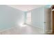 Bright bedroom featuring light wood floors, and a window letting in natural sunlight at 10848 Tailwater St, Davidson, NC 28036