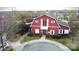 A high aerial view showcases the charming red clubhouse with manicured landscaping and convenient parking at 10848 Tailwater St, Davidson, NC 28036