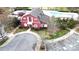 Aerial view of the barn-style clubhouse with inviting architecture and beautiful landscaping, near the pool and parking at 10848 Tailwater St, Davidson, NC 28036