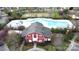 Community pool and club house viewed from above featuring mature trees, seating and landscaping at 10848 Tailwater St, Davidson, NC 28036