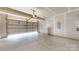 Garage featuring a garage door, with exposed drywall and an overhead light at 10848 Tailwater St, Davidson, NC 28036