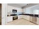 Modern kitchen with white cabinets, stainless steel appliances, and granite countertops at 10848 Tailwater St, Davidson, NC 28036