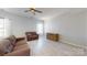 Bright living room with neutral colors and wood-look floors at 10848 Tailwater St, Davidson, NC 28036