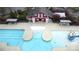 Aerial shot of a community pool with a pool house, covered seating areas, and a slide at 10848 Tailwater St, Davidson, NC 28036