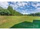 Expansive backyard featuring lush green grass and mature trees, ideal for outdoor activities and relaxation at 1110 S New Hope Rd, Gastonia, NC 28054