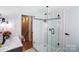 Modern bathroom featuring a glass enclosed shower with light tiles and gray vanity at 1110 S New Hope Rd, Gastonia, NC 28054
