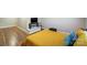 Comfortable bedroom with wood floors, TV, and yellow comforter offers a relaxing space at 1110 S New Hope Rd, Gastonia, NC 28054