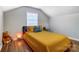 Well-lit bedroom with a yellow comforter, wood floors, and a cozy atmosphere at 1110 S New Hope Rd, Gastonia, NC 28054