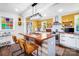 Eat-in kitchen featuring a center island with seating, stainless steel appliances, and bright yellow paint at 1110 S New Hope Rd, Gastonia, NC 28054
