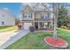 Charming two-story home with a stone accent front, well-manicured lawn, and inviting front porch at 1135 Valley St, Statesville, NC 28677