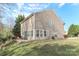 The back exterior view shows a brick patio, lush yard, and home siding at 1135 Valley St, Statesville, NC 28677