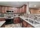 Modern kitchen with stainless steel appliances, granite countertops, and backsplash at 1135 Valley St, Statesville, NC 28677