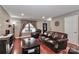 Cozy living room features dark wood furniture, hardwood floors, and a large window at 1135 Valley St, Statesville, NC 28677