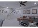 Spacious basement with stairs and a brown sectional sofa. Recessed lights in ceiling at 119 Capital Ave # E, Mooresville, NC 28117