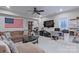 Spacious basement with a brown sectional sofa, mounted TV, and a desk at 119 Capital Ave # E, Mooresville, NC 28117