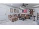 Spacious basement with a brown sectional sofa, wall art, and a drum set at 119 Capital Ave # E, Mooresville, NC 28117