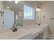 This bathroom features dual sinks, quartz countertops, dark fixtures, and a large framed mirror at 119 Capital Ave # E, Mooresville, NC 28117