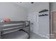 This bedroom features a bunk bed, wall shelves, and a closet at 119 Capital Ave # E, Mooresville, NC 28117