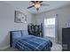 Comfortable bedroom with a ceiling fan, window, and desk at 119 Capital Ave # E, Mooresville, NC 28117