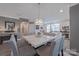 Elegant dining area with a marble-top table, stylish chandelier, and views into the modern kitchen at 119 Capital Ave # E, Mooresville, NC 28117