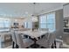 Modern dining area with a marble-top table, seating for six, and an open view of the kitchen at 119 Capital Ave # E, Mooresville, NC 28117