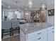 Open concept kitchen featuring a granite island with seating, stainless steel appliances, and modern lighting at 119 Capital Ave # E, Mooresville, NC 28117