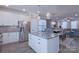 Bright, modern kitchen with stainless steel appliances, granite counters, and an open view to the living area at 119 Capital Ave # E, Mooresville, NC 28117