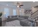 Bright living room with a comfortable sectional sofa, large windows, and hardwood floors at 119 Capital Ave # E, Mooresville, NC 28117