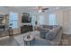 Cozy living room with a plush sectional sofa, large windows, and elegant decor at 119 Capital Ave # E, Mooresville, NC 28117