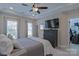 This main bedroom features a tray ceiling, a ceiling fan, an en-suite bathroom, and a walk-in closet at 119 Capital Ave # E, Mooresville, NC 28117
