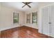 Cozy bedroom with hardwood flooring, three windows, and a closet at 119 E End Ave, Statesville, NC 28677