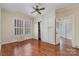 Cozy bedroom features hardwood floors, built-in cabinets, and a ceiling fan at 119 E End Ave, Statesville, NC 28677